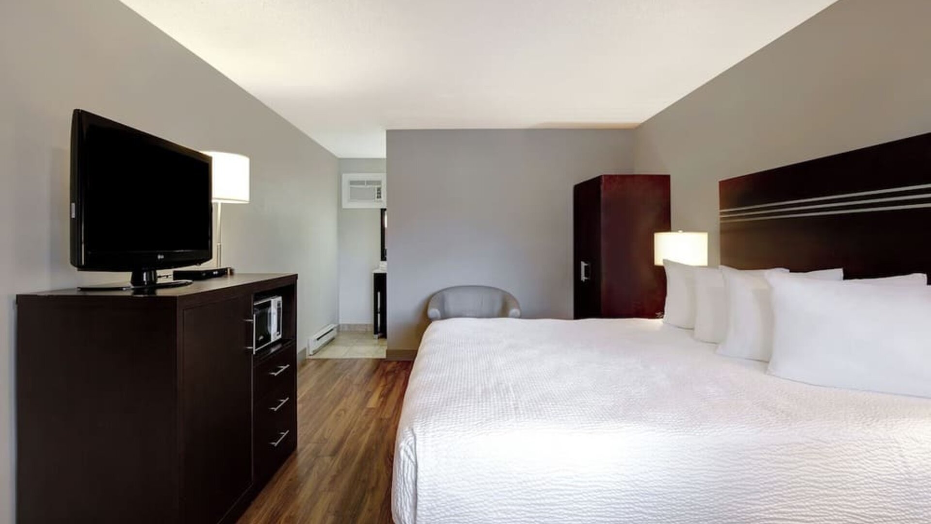 Guest room with a king bed and TV at Days Inn Vernon.