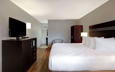 Guest room with a king bed and TV at Days Inn Vernon.