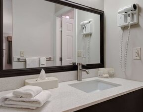 Guest bathroom vanity with sink and amenities at Days Inn Vernon.