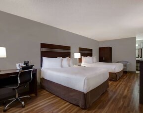 Guest room with two queen beds and work desk at Days Inn Vernon.