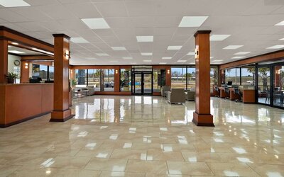 Spacious hotel lobby with polished tile floors, seating areas and large glass entrance doors at Quality Inn Yemassee - Point South I-95.