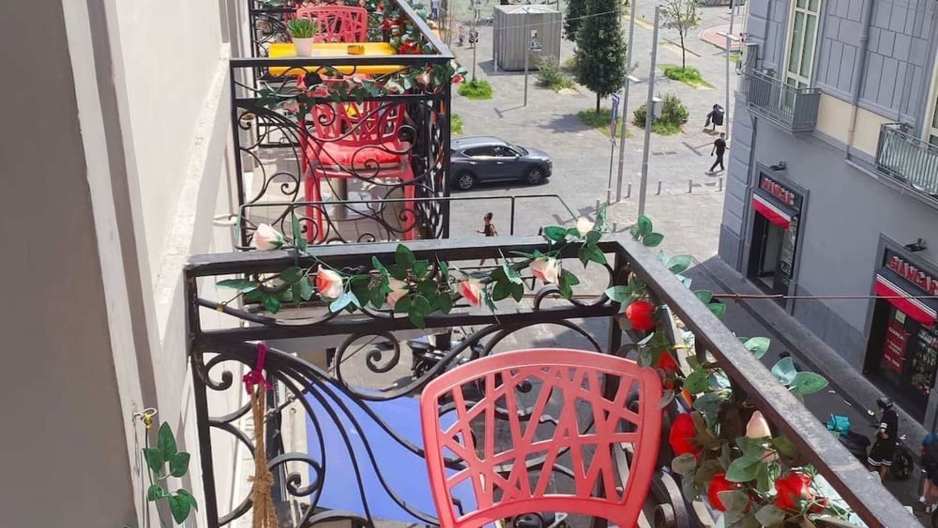 Private balcony with colorful seating and city views at Dolce Vita Rooms & Breakfast.