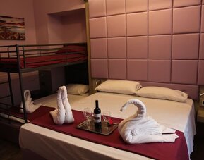 Spacious family room with one double bed, bunk beds and modern amenities at Dolce Vita Rooms & Breakfast.