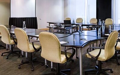 Fully equipped meeting room with conference tables, ergonomic seating and presentation space at NH Collection Mexico City Airport T2.