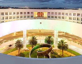 Aerial exterior view of NH Collection Mexico City Airport T2 showcasing the hotel's distinctive circular architecture and landscaped central courtyard.