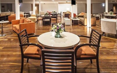 Stylish restaurant and lounge area with contemporary seating, dining tables and relaxed atmosphere at NH Collection Mexico City Airport T2.