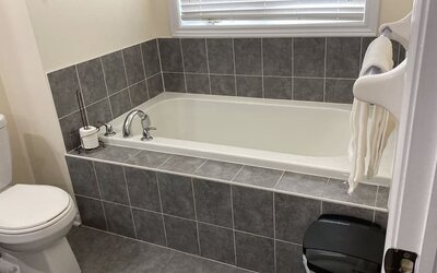 Guest bathroom with tub at Home Stay Canada.