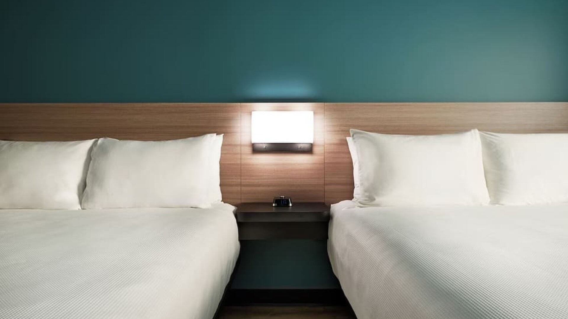 Guest room with two queen beds, modern headboards and comfortable bedding at Hyatt Select Philadelphia Airport.