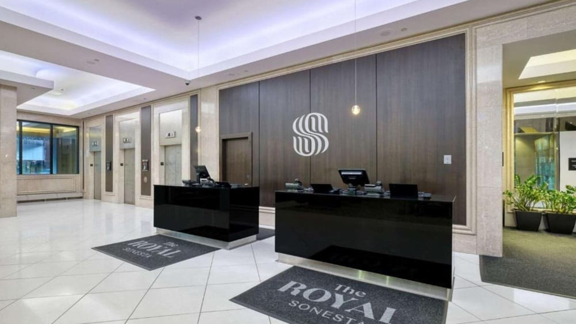 Elegant hotel lobby with a modern reception desk, polished floors and contemporary décor at Royal Sonesta Minneapolis.