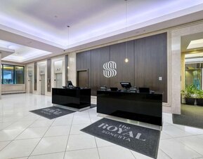 Elegant hotel lobby with a modern reception desk, polished floors and contemporary décor at Royal Sonesta Minneapolis.
