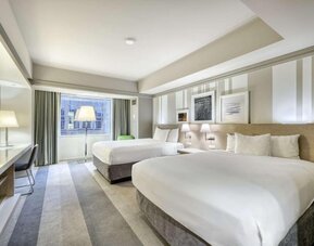 Modern guest room with two queen beds, stylish artwork and a comfortable contemporary design at Royal Sonesta Minneapolis.
