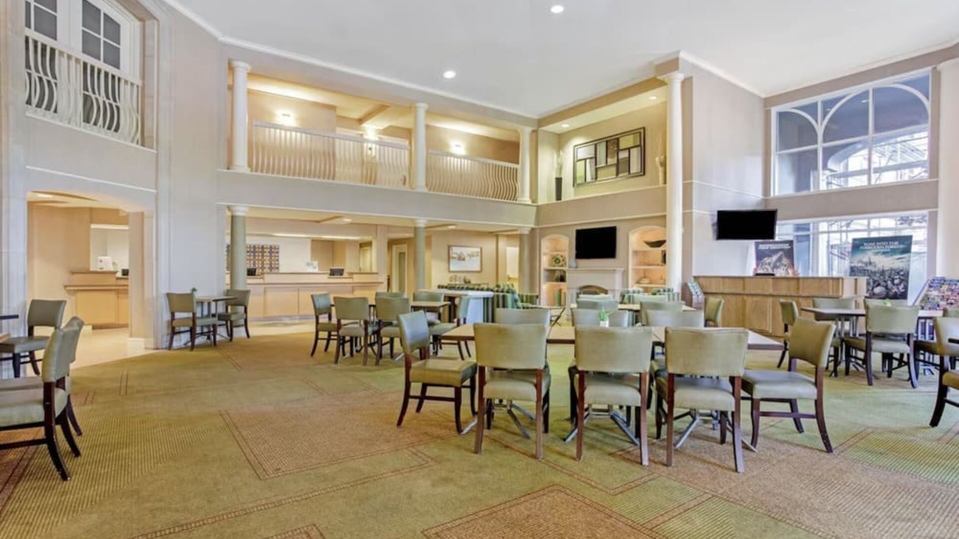 Spacious hotel lobby featuring comfortable seating, an open layout and a welcoming atmosphere at La Quinta Inn & Suites By Wyndham Orlando I Drive/Conv Ctr.