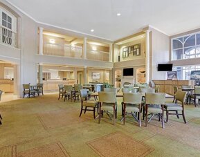 Spacious hotel lobby featuring comfortable seating, an open layout and a welcoming atmosphere at La Quinta Inn & Suites By Wyndham Orlando I Drive/Conv Ctr.