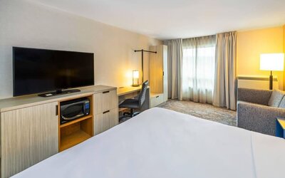 Guest room featuring an in-room workspace, a microwave, a flat-screen television and comfortable seating at Comfort Inn Truro.