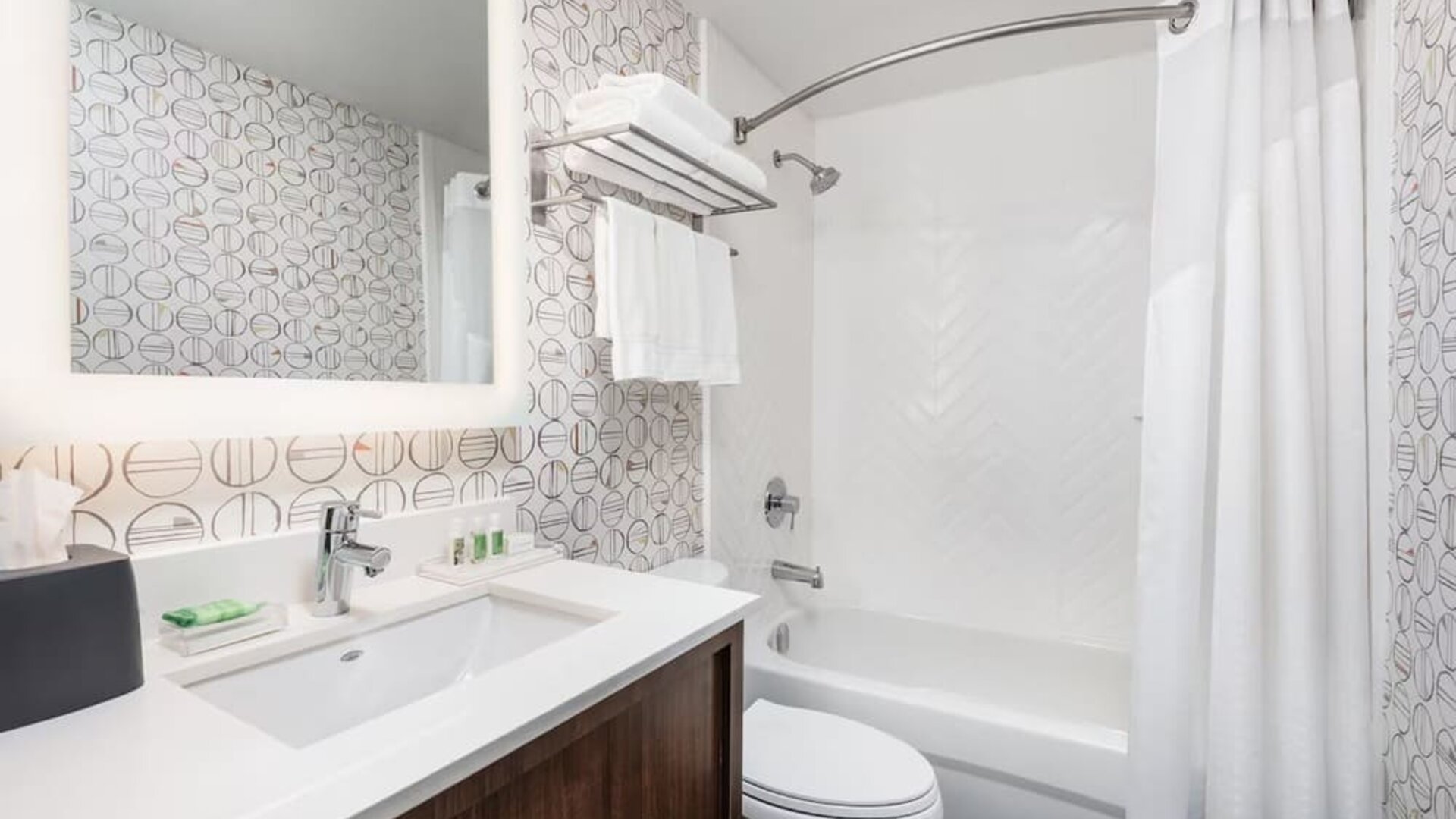 Contemporary bathroom featuring a spacious vanity, modern fixtures and a tub and shower combination at Holiday Inn Toronto Airport East.