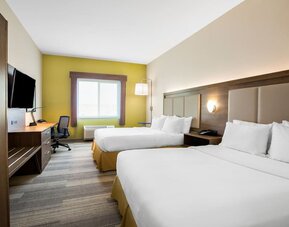 Guest room featuring two beds, a spacious layout, a work desk and contemporary furnishings designed for comfort at Holiday Inn Express & Suites Ontario.