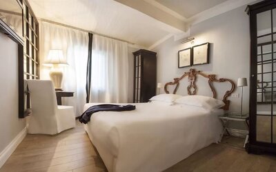 Day room featuring a plush bed, soft lighting, elegant furnishings, and a relaxing atmosphere at Cellai Boutique Hotel.