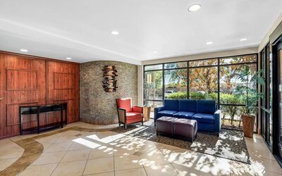 Bright lobby seating area with comfortable sofas, armchairs, large windows, and contemporary décor at Comfort Suites Vacaville-Napa Valley Area.