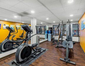 Fitness centre equipped with cardio machines, strength-training equipment, and mirrored walls at Comfort Suites Vacaville-Napa Valley Area.
