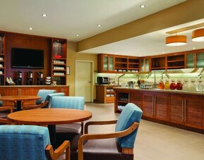Bright dining area featuring comfortable seating, beverage stations, and a breakfast buffet counter at Hyatt Place San Jose Downtown.