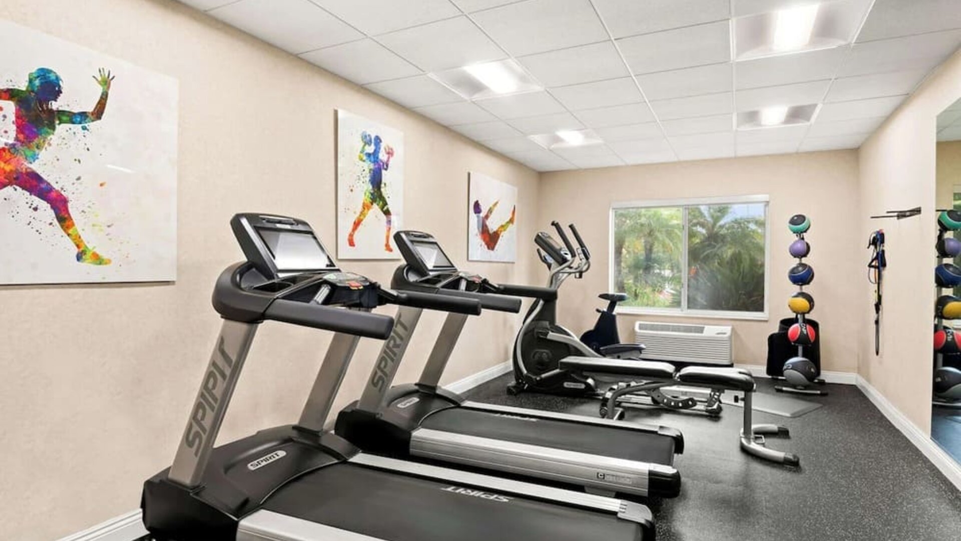 Fitness centre with treadmills, elliptical equipment, exercise bench, and medicine balls at Best Western Ontario Mills Mall.