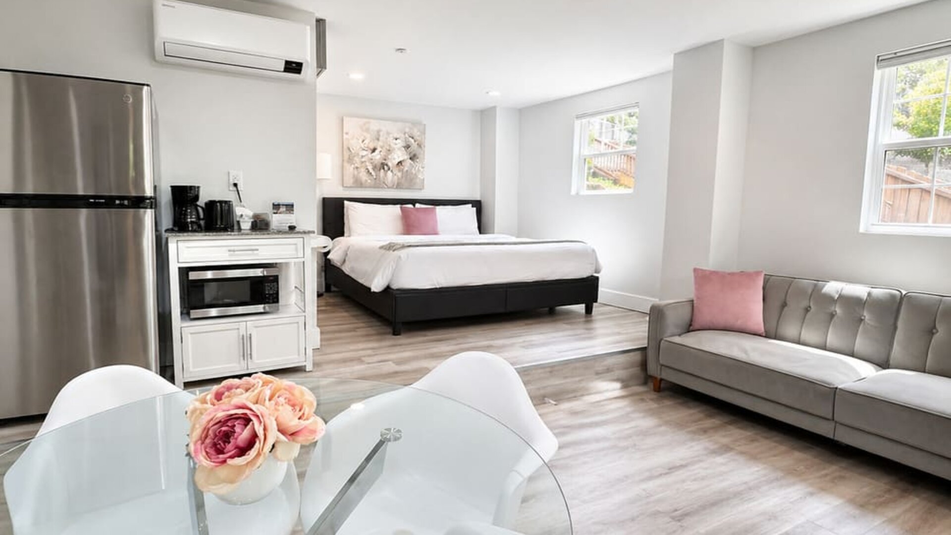 Spacious guest accommodation featuring a bed, sofa, dining area, refrigerator, kitchenette, and contemporary furnishings at SKYLARANNA Resort & Spa.