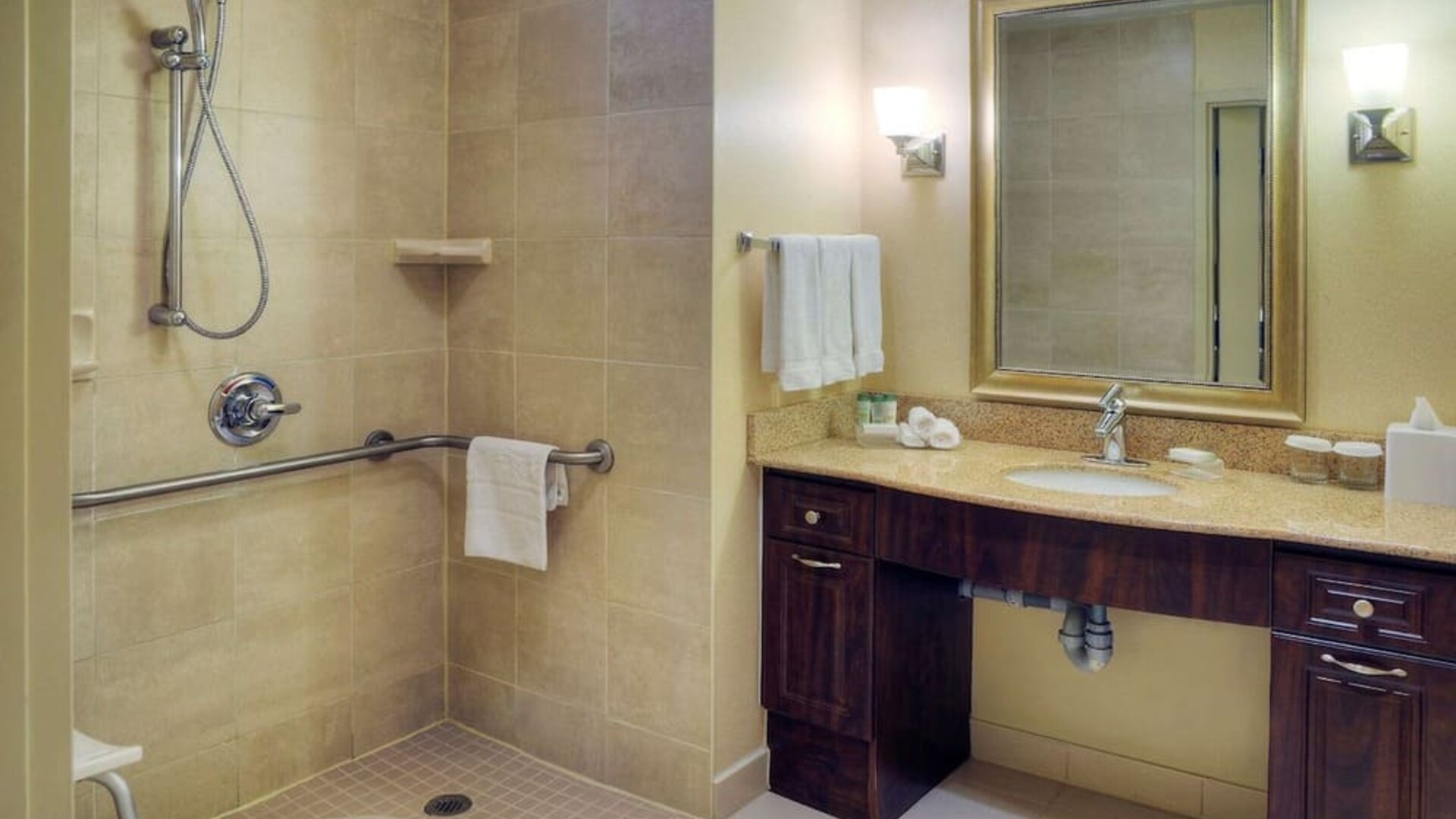Guest bathroom with shower and toiletries at Homewood Suites By Hilton Burlington.