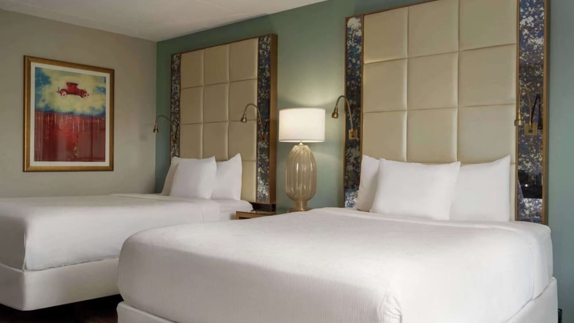 Comfortable guest room featuring two beds, contemporary headboards, bedside lighting, and modern décor at Wyndham Garden Pittsburgh Airport.