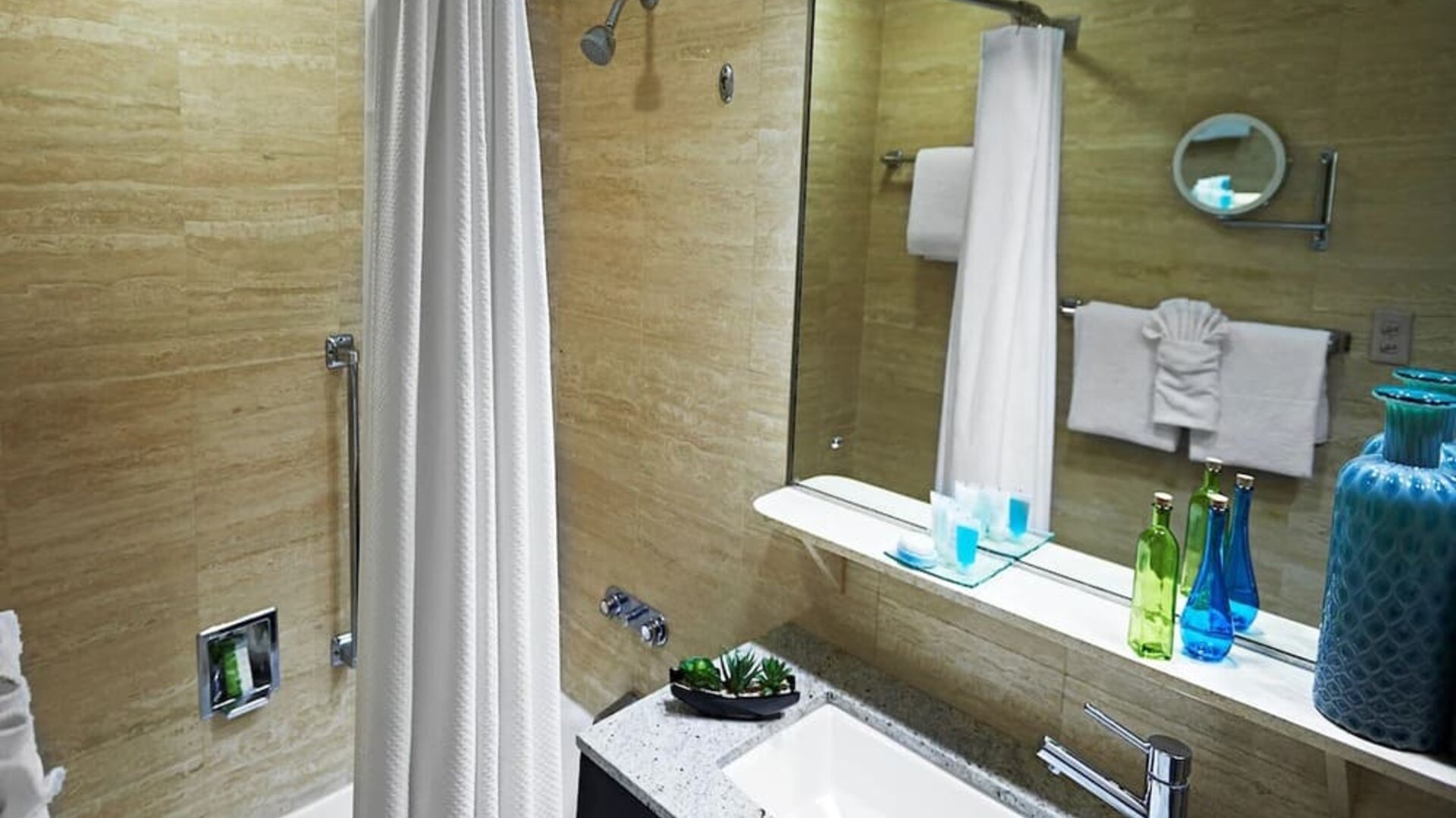 Guest bathroom with shower and tub at Miami International Airport Hotel.