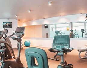 Fitness center with treadmills, stationary bikes, strength equipment, exercise ball, and mirrored walls at Dazzler by Wyndham Buenos Aires Recoleta.