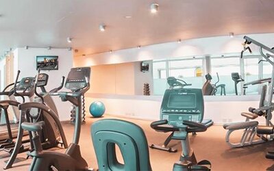 Fitness center with treadmills, stationary bikes, strength equipment, exercise ball, and mirrored walls at Dazzler by Wyndham Buenos Aires Recoleta.