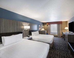 uest room with two beds, television, dresser, and seating area at Best Western Plus Mountain View Auburn Inn.