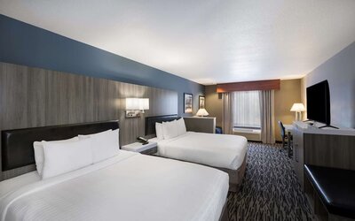 uest room with two beds, television, dresser, and seating area at Best Western Plus Mountain View Auburn Inn.
