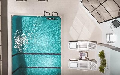 Outdoor swimming pool viewed from above, surrounded by lounge chairs and a paved pool deck at Ramada by Wyndham Buenos Aires Centro.