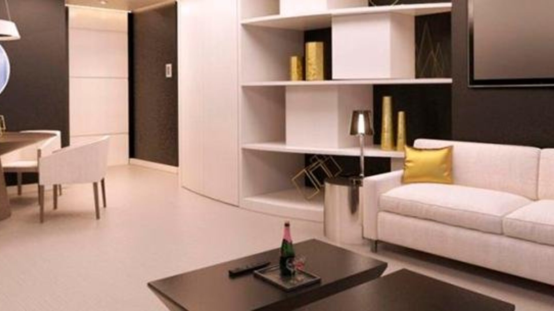 Modern hotel suite lounge with cream sofas, gold accent cushions, a coffee table and built-in shelving at Hotel Las Américas Golden Tower Panamá.