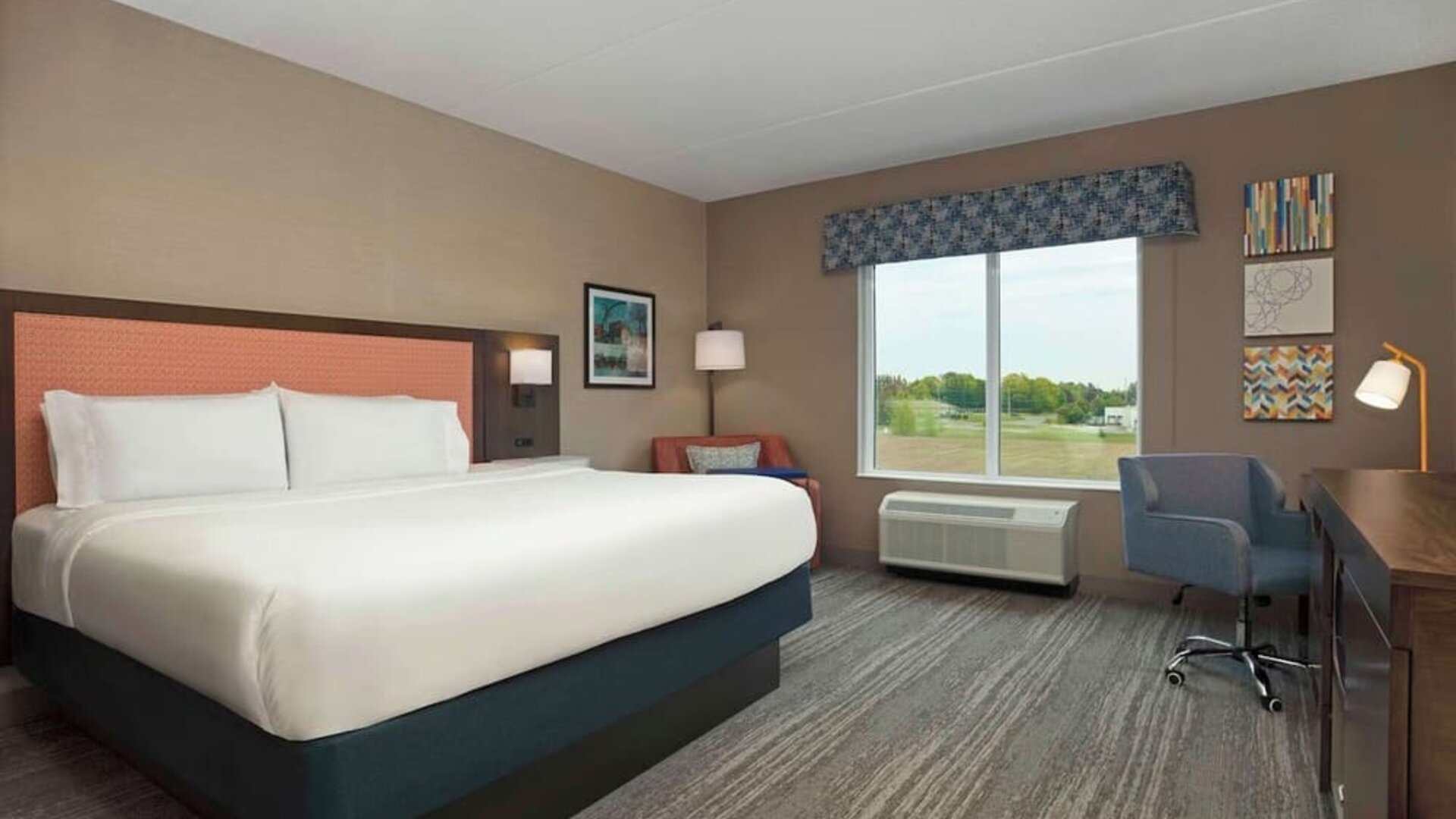 Bright day use king room with TV and work desk at Hampton Inn By Hilton Port Hope.