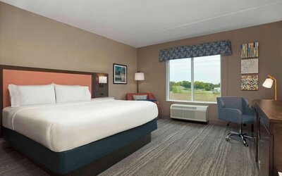 Bright day use king room with TV and work desk at Hampton Inn By Hilton Port Hope.