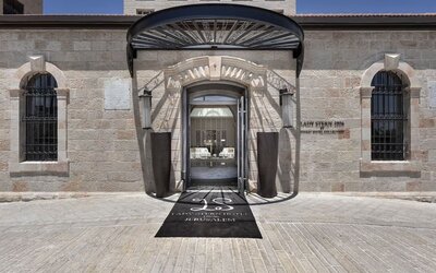 Main hotel entrance with stone façade, arched doorway and covered entrance canopy at Lady Stern Hotel.