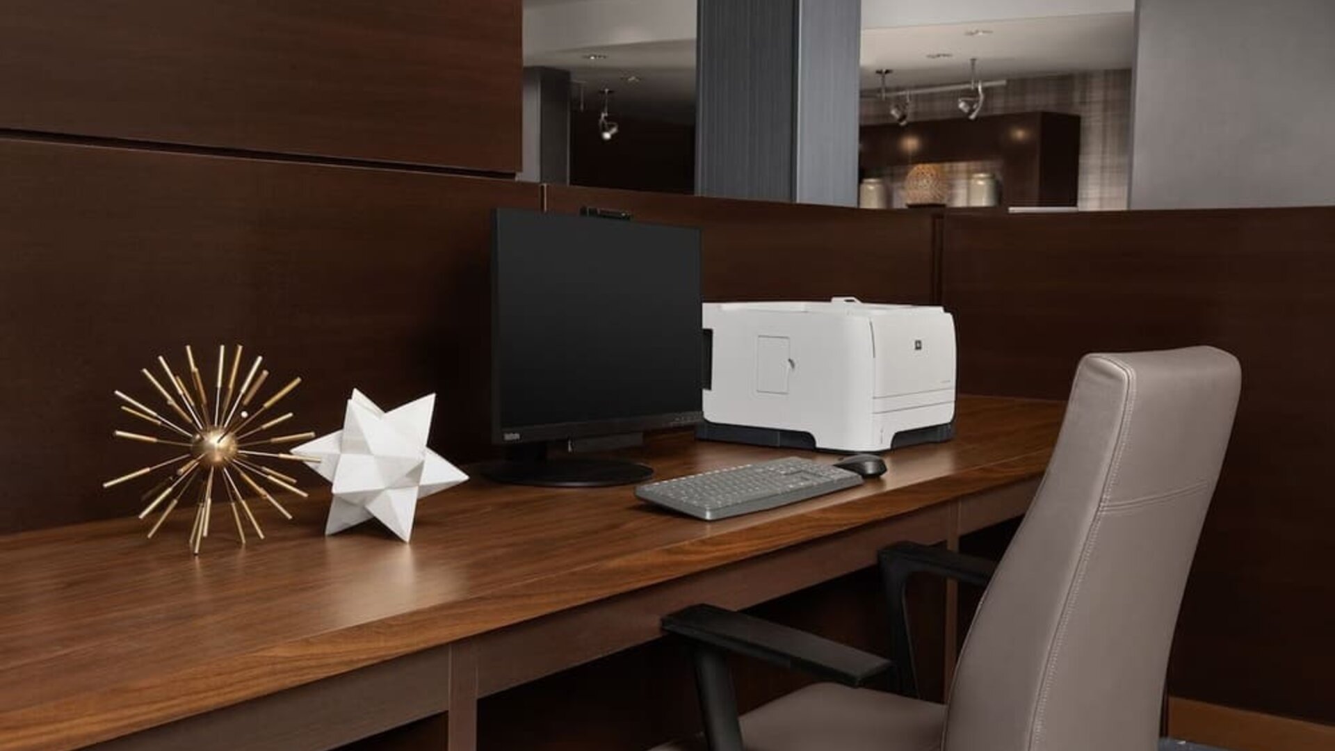 Business center with computer monitor, printer, keyboard, decorative ornaments and a wooden workstation at Courtyard By Marriott Dothan.