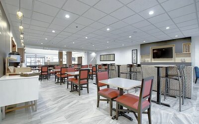 Dining area with comfortable mobiliary perfect for co-working at Holiday Inn Express & Suites Airport-Calgary.