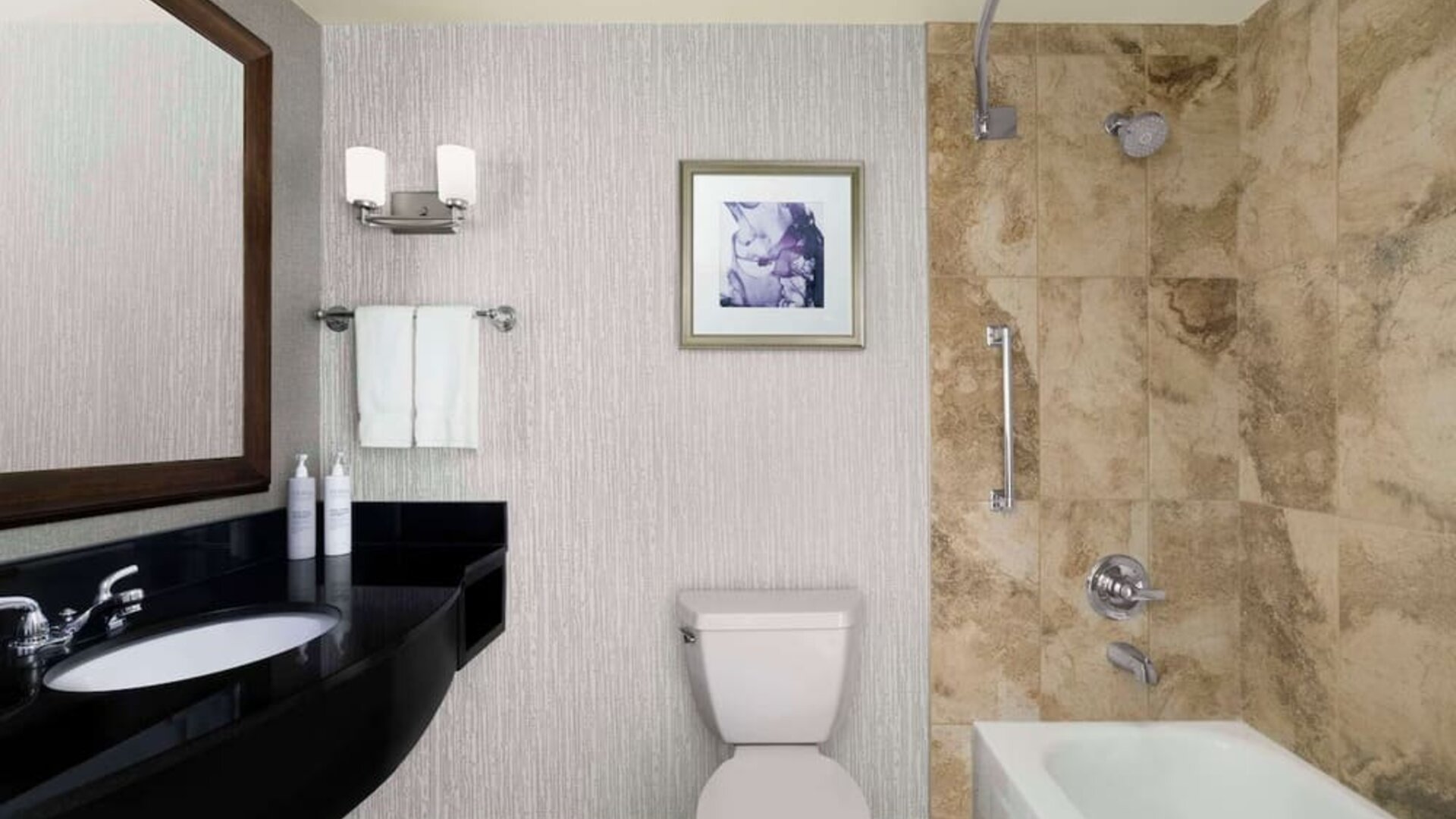 Day use guest bathroom with shower and tub at Hilton Garden Inn Calgary Airport.