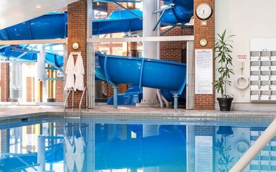 Indoor pool with spiral slide at Hilton Mississauga Meadowvale.