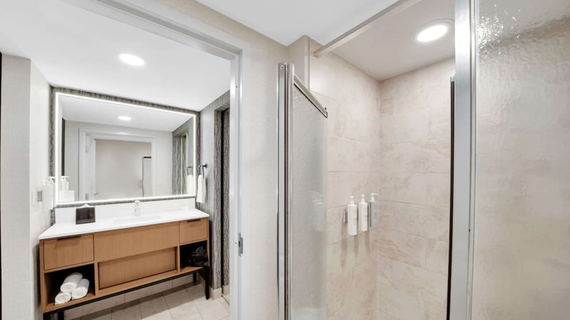 Private guest bathroom with shower and free toiletries at Homewood Suites By Hilton Toronto-Markham.