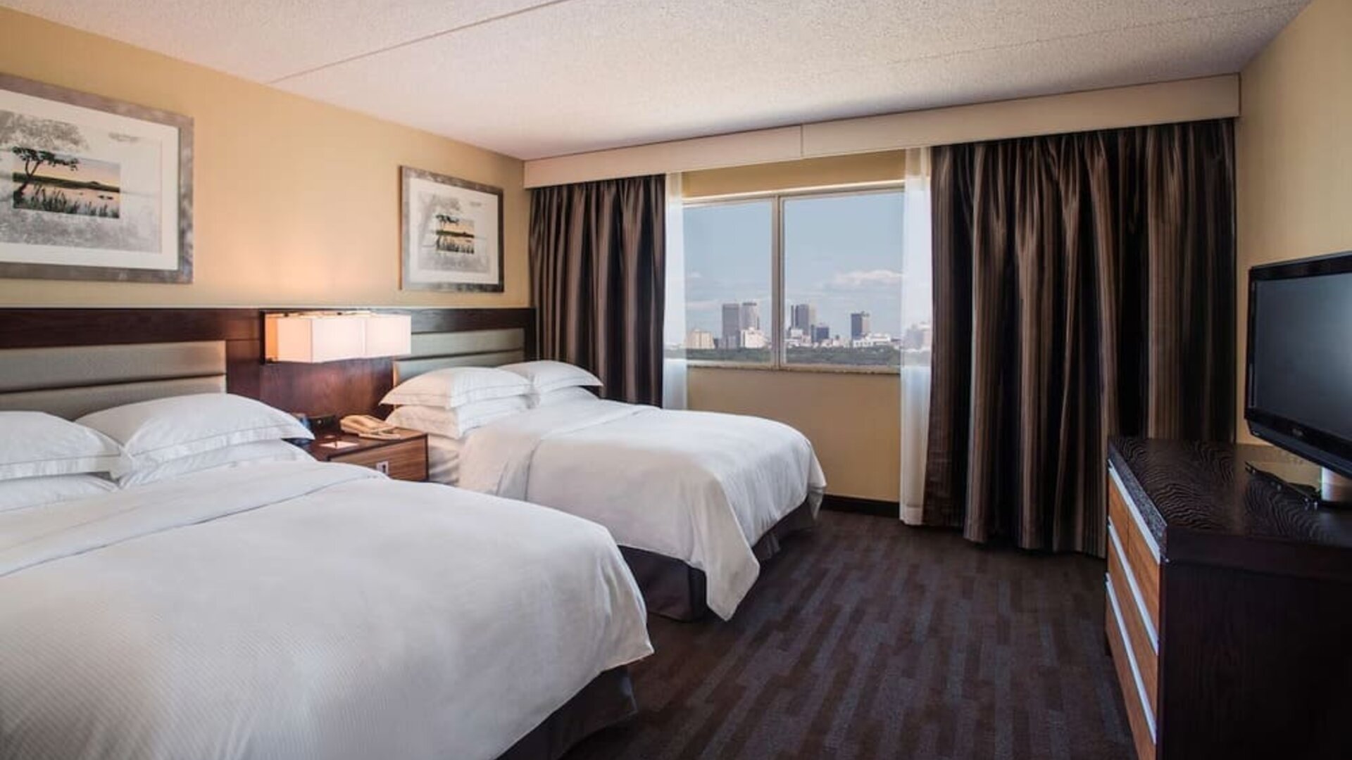 Twin day use room with TV and private bathroom at Hilton Winnipeg Airport Suites.
