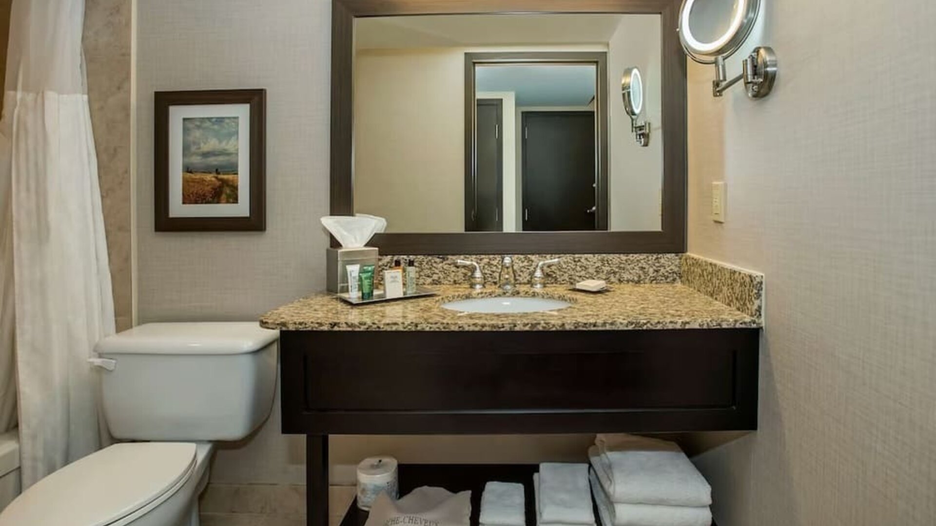 Private bathroom with shower and free toiletries at Hilton Winnipeg Airport Suites.