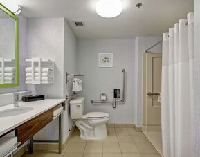Private guest bathroom with shower and free toiletries at the  Hampton Inn & Suites By Hilton Guelph.