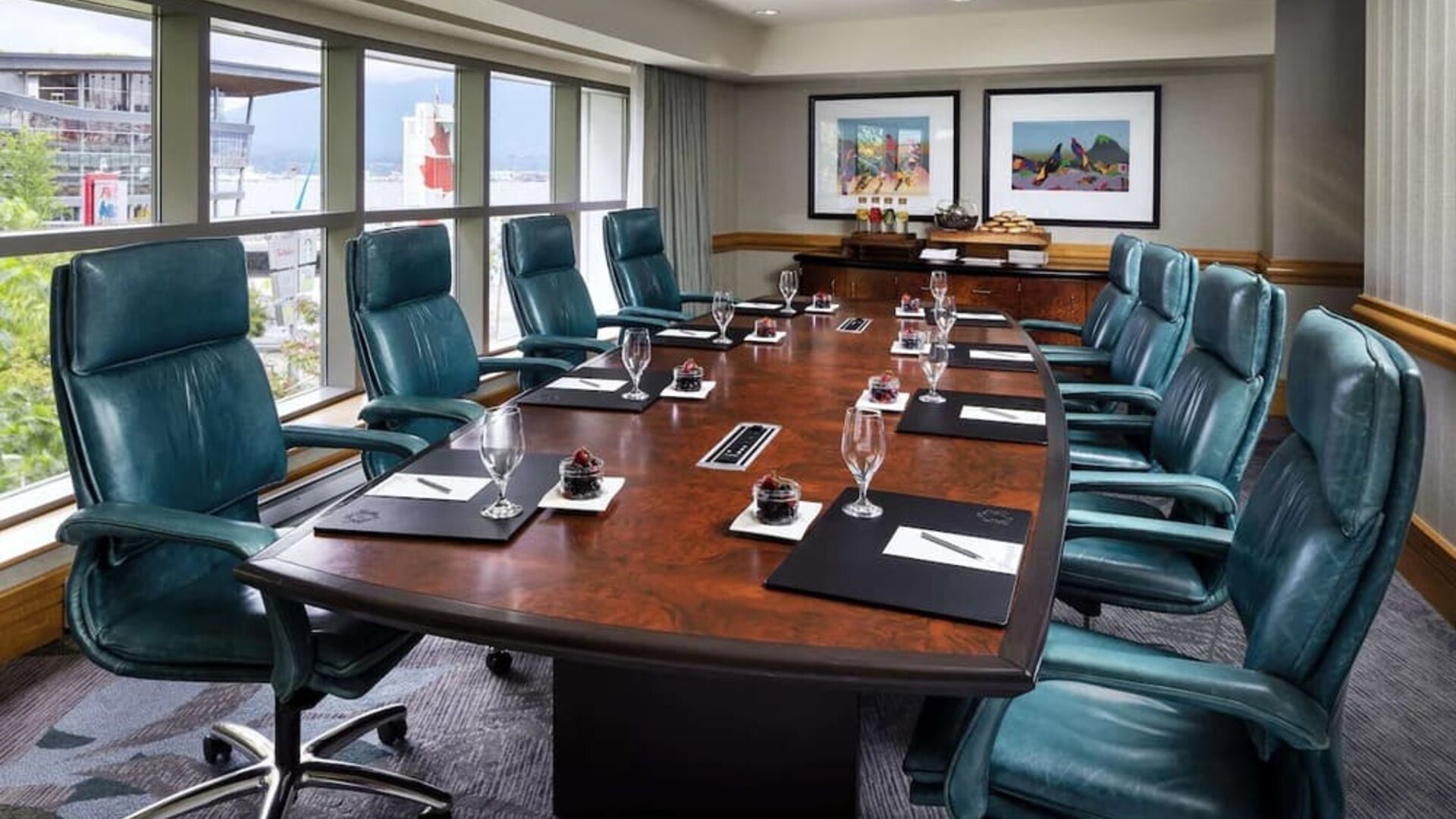 Professional meeting room with large windows and ergonomic chairs at the Fairmont Waterfront.