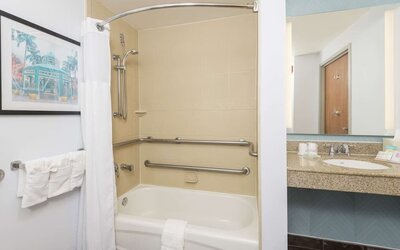 Guest bathroom with shower and tub at Hilton Garden Inn Boca Raton.