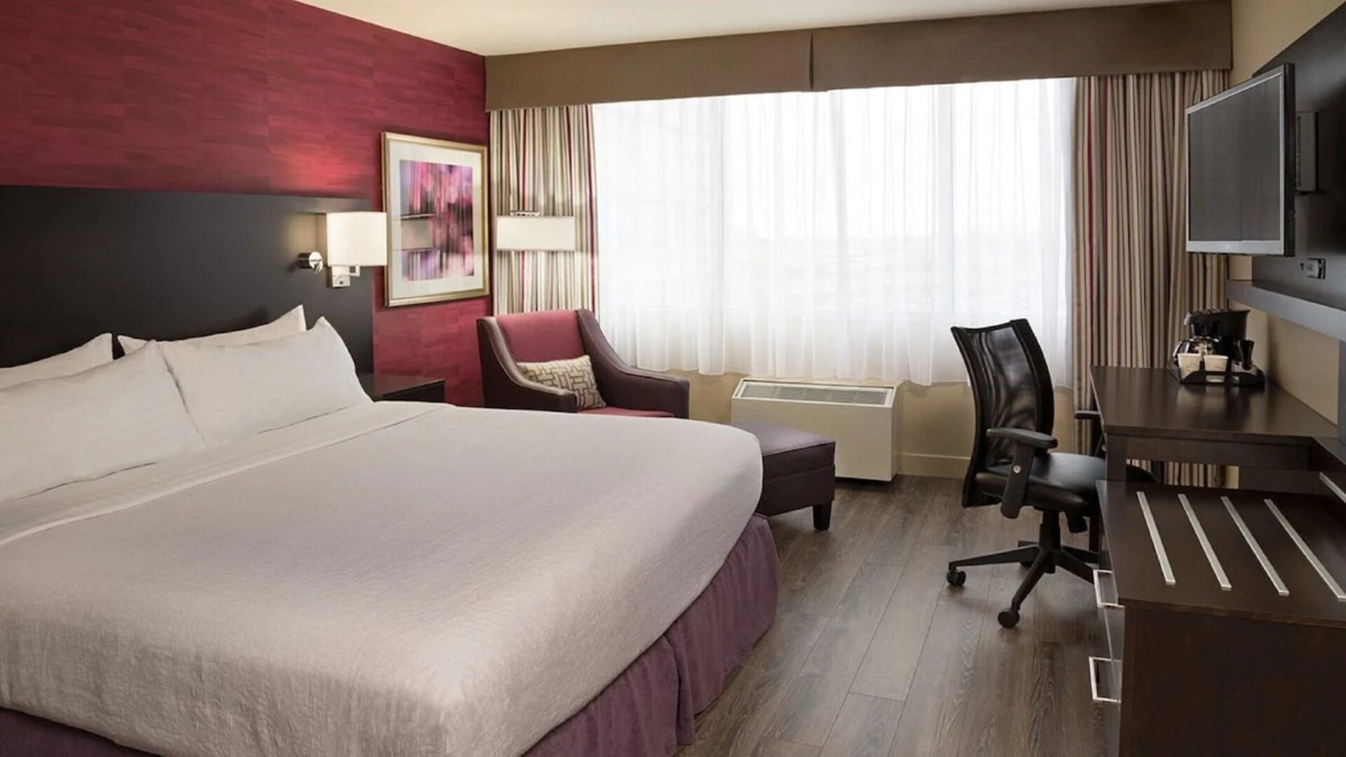 Day use room with king bed, sofa, TV, work desk and private bathroom at Holiday Inn Toronto International Airport.