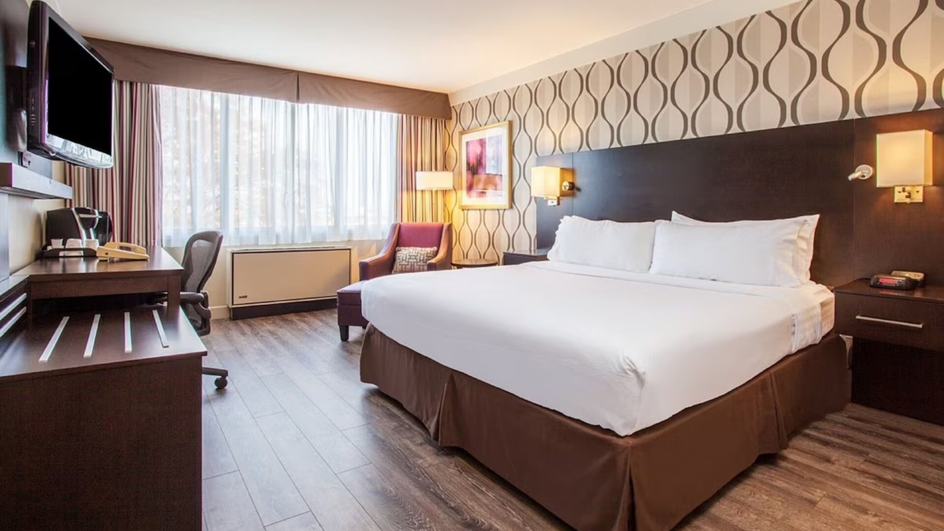 Day use room with TV, sofa, work desk and private bathroom at Holiday Inn Toronto International Airport.